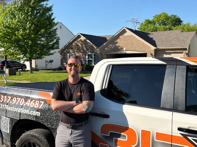 David Denton, founder of 317 Roofing Co., with the 317 Roofing Co. truck in Indianapolis